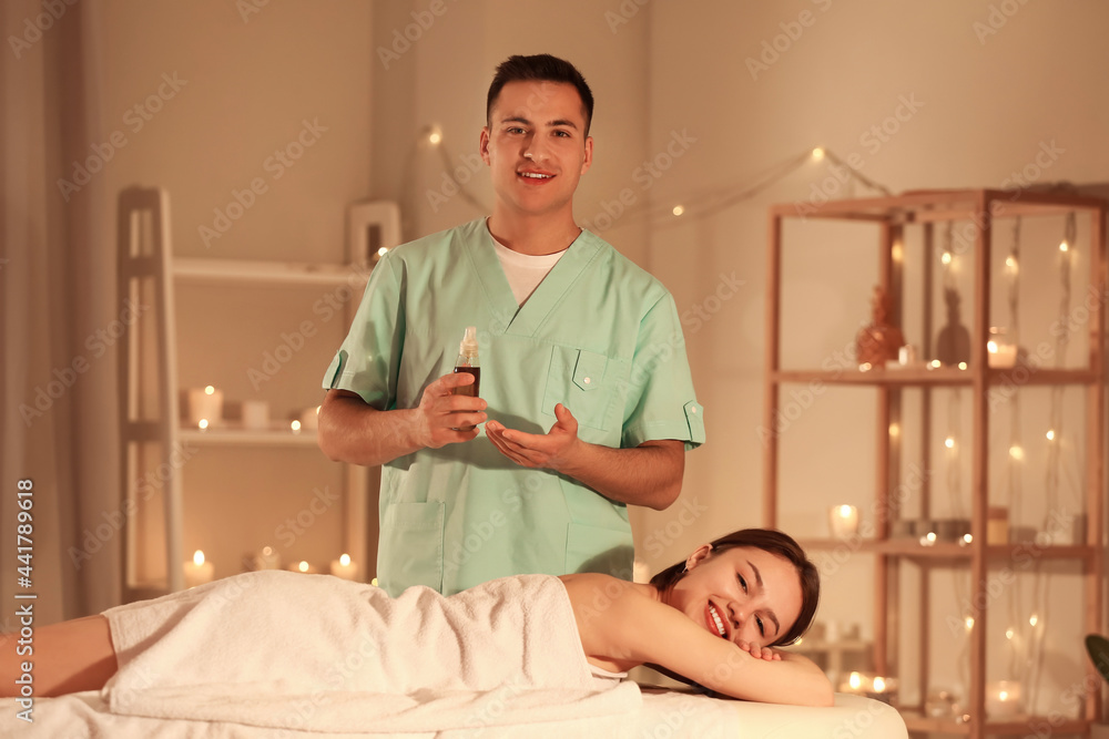 Fototapeta premium Young woman having massage in spa salon