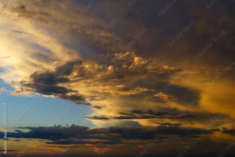 beautiful sunset sky, bright sunlight and silhouette of clouds as a background