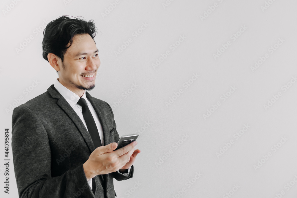 Happy smile face of Asian businessman use smartphone in concept of trading app. Happy smile face of Asian businessman use smartphone in concept of trading app.