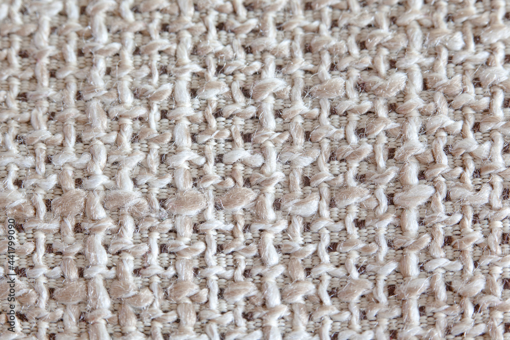 The texture of the fabric with a coarse weave of threads in natural beige tones, matting, close-up. The texture of the fabric with a coarse weave of threads in natural beige tones, matting, close-up.