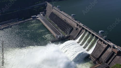 Hydroelectric dam on the river, water discharge from the reservoir, aerial footage