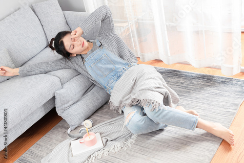 Fotografie Asian girl lying on the carpet sleeping