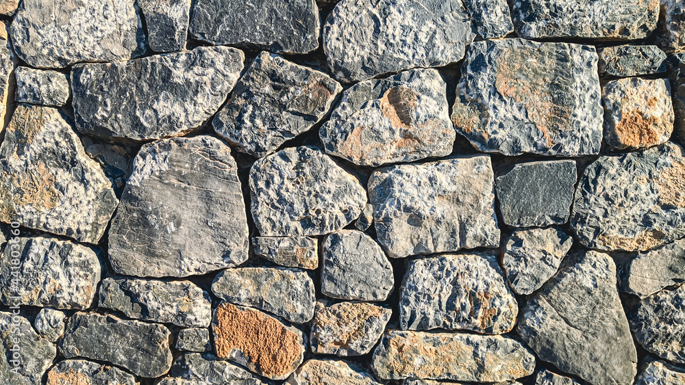 stone wall texture.

Abstract texture of stones large and small rocky wall, side view close-up.