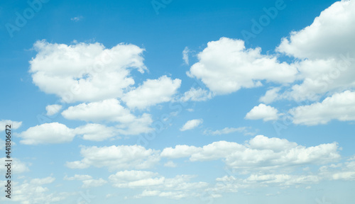Blue sky with white fluffy clouds, perfect sunny day background