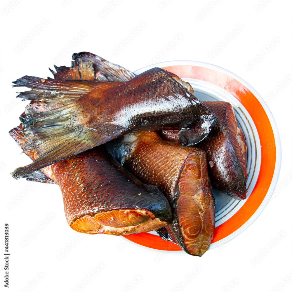 Obraz premium Smoked salmon meat on a plate. The object is isolated on a white background. Hot smoked fish close-up. Image for project and design