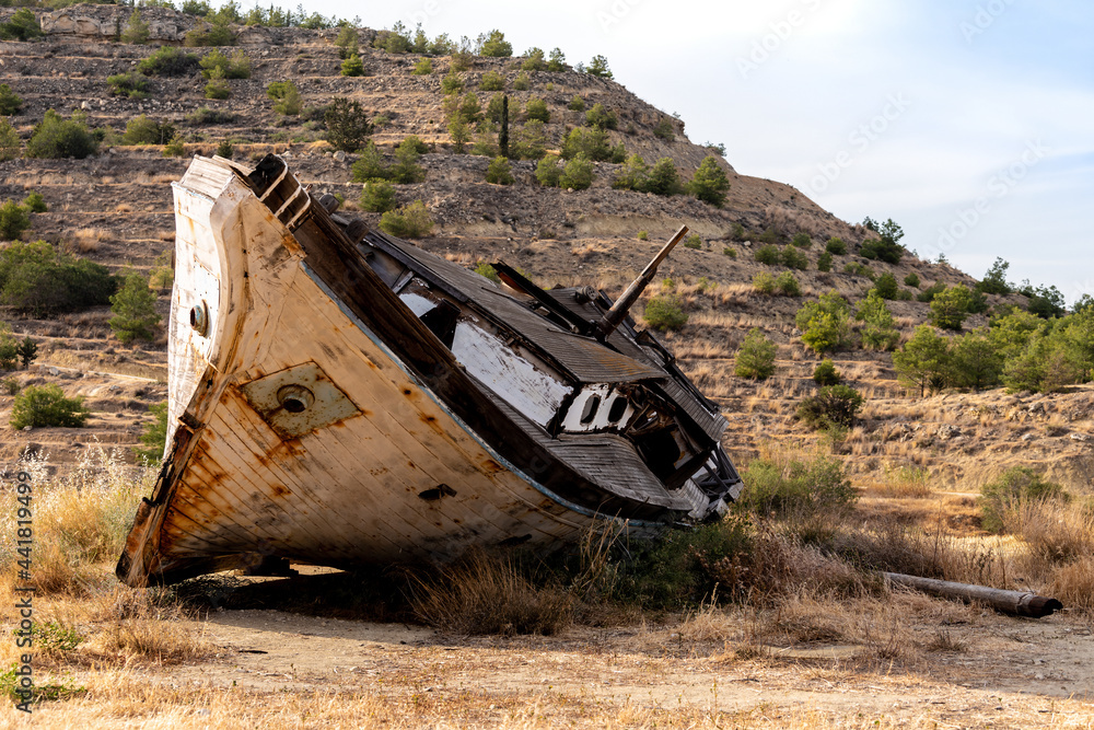 An old destroyed boat abandoned on a mountainside near Larnaca, Cyprus.