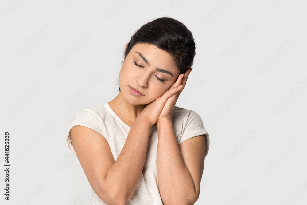 Tired young Indian woman isolated on grey studio background feel fatigue fall asleep take nap. Exhausted millennial mixed race female daydream, asleep on hands. Exhaustion, relaxation concept. Tired young Indian woman isolated on grey studio background feel fatigue fall asleep take nap. Exhausted millennial mixed race female daydream, asleep on hands. Exhaustion, relaxation concept.