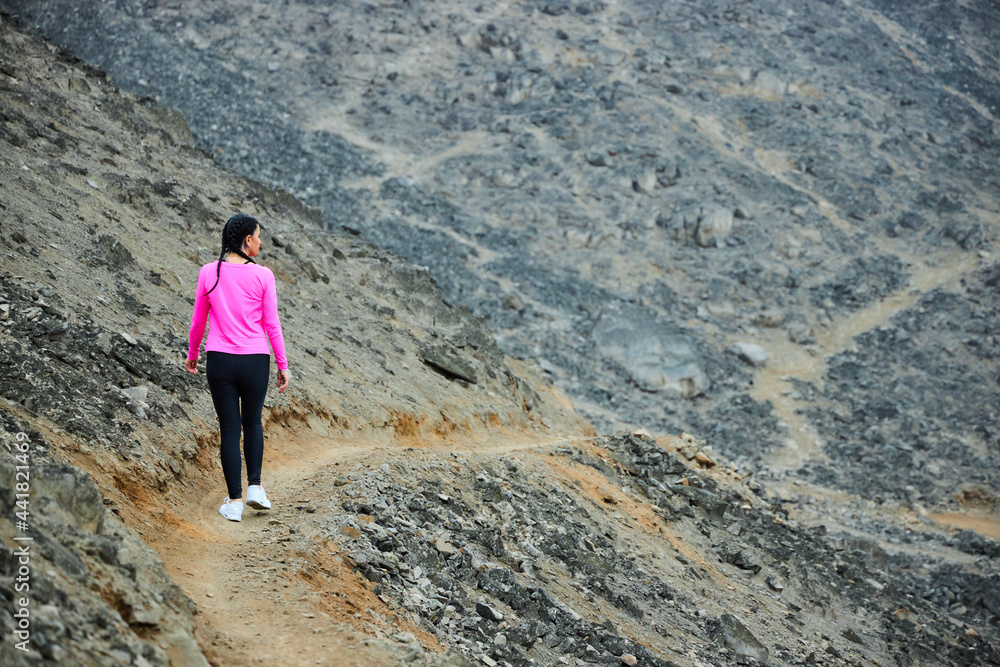 mature woman running in the mountain