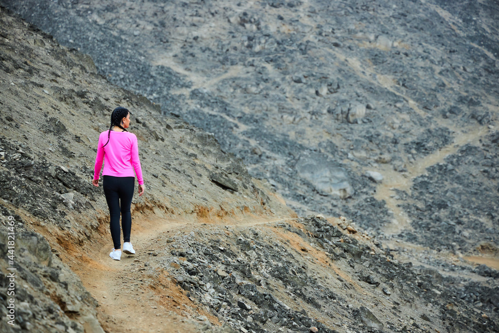 Obraz premium mature woman running in the mountain