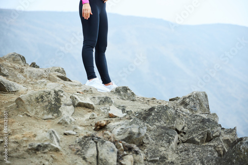 woman in white sneakers in the mountain