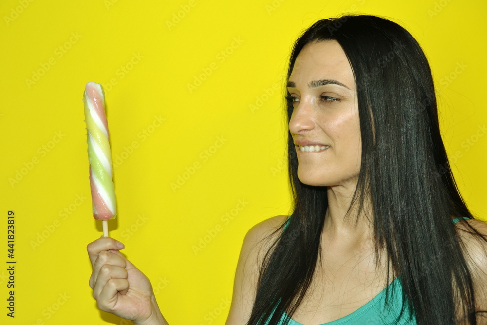 Profile half face portrait with copy space empty place for advertisement of naughty seductive girl want eat ice cream gesturing showing tongue out isolated on yellow background Profile half face portrait with copy space empty place for advertisement of naughty seductive girl want eat ice cream gesturing showing tongue out isolated on yellow background