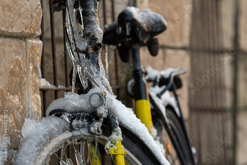close-up of a bicycle wrapped in ice and icicles