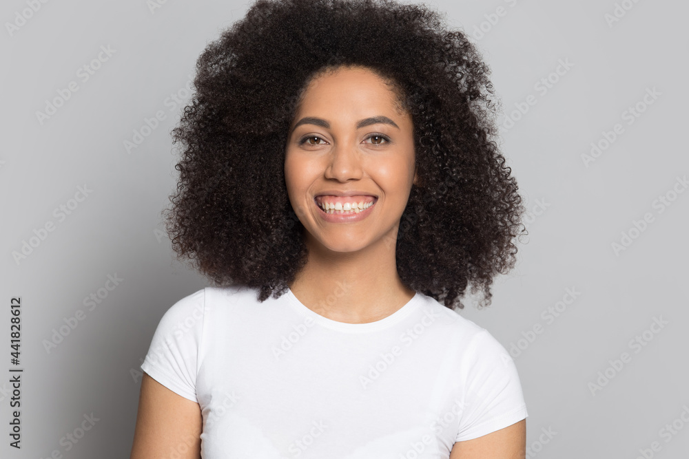 Profile picture of happy millennial African American woman isolated on grey studio background feel excited. Headshot portrait of smiling young mixed race female laugh. Diversity, ethnicity concept. Profile picture of happy millennial African American woman isolated on grey studio background feel excited. Headshot portrait of smiling young mixed race female laugh. Diversity, ethnicity concept.