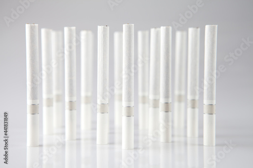 Closeup of a pile of cigarettes over white background 