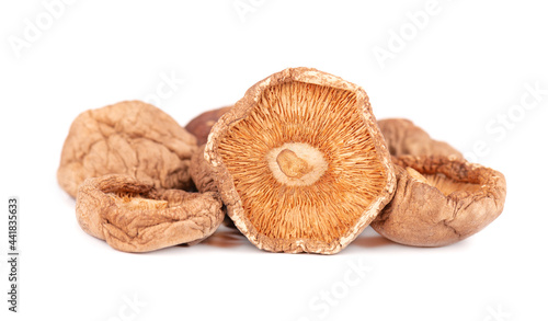 Dried shiitake mushrooms, isolated on white background. Japanese forest mushroom. Lentinula edodes. Close up.