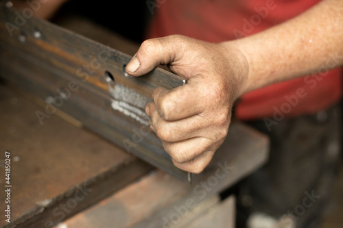 Drilled holes in the metal. Work in a metal workshop.