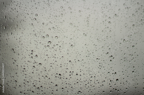 Raindrops on glass. Wet weather outside the window.