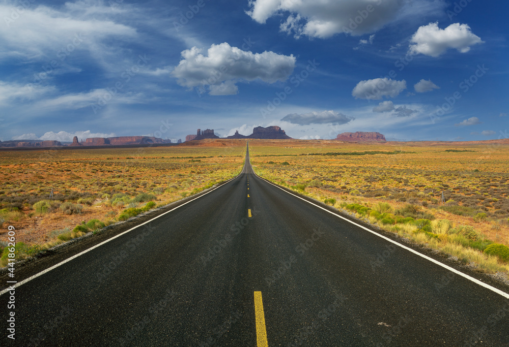 Arizona, Monument Valley Tribal Park, Empty road in desert leading to Monument Valley Arizona, Monument Valley Tribal Park, Empty road in desert leading to Monument Valley