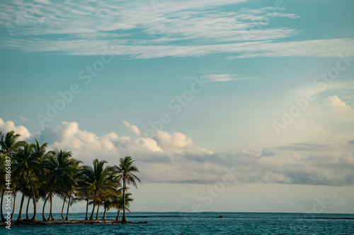 Small tropical island with coconut palm trees and white sand beach. Adventure and travel concept 