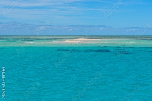 Sand cay in the Great Barrier Reef surrounded by crystal clear water
