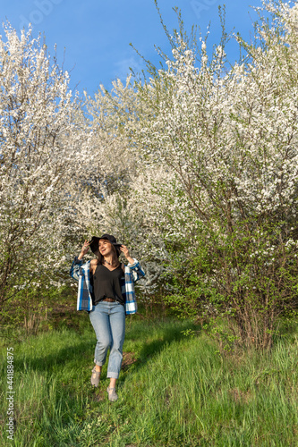 Attractive girl on a walk in the spring forest in a casual style. © puhimec