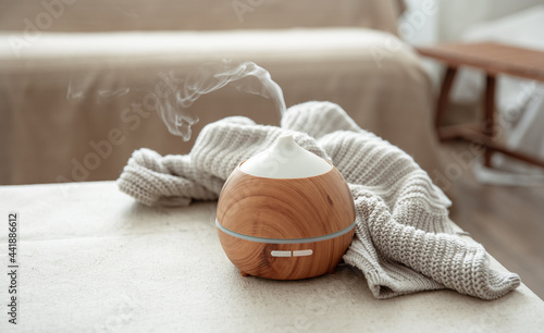 Close-up of a humidifier and knitted element on a blurred background.