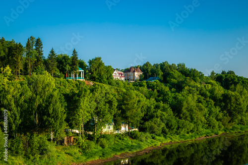 beautiful little houses are located on the picturesque steep bank of the river