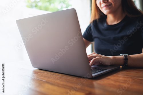 A young asian woman using and working on laptop computer
