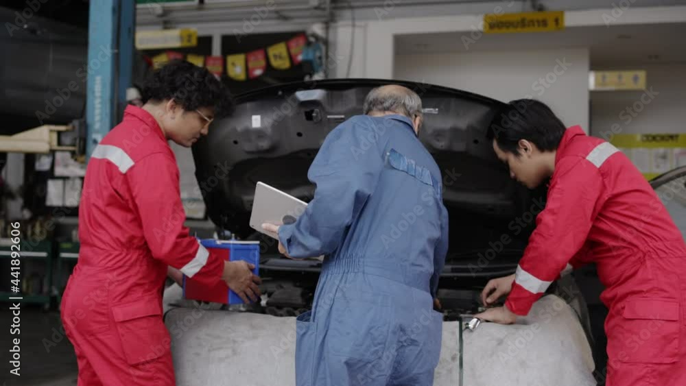 Group of auto mechanic Check condition car of factory. oil engine maintenance service technician. combustion engine service center. System analysis of the machine Group of auto mechanic Check condition car of factory. oil engine maintenance service technician. combustion engine service center. System analysis of the machine