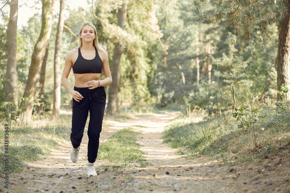 Beautiful woman runs in a summer park Beautiful woman runs in a summer park