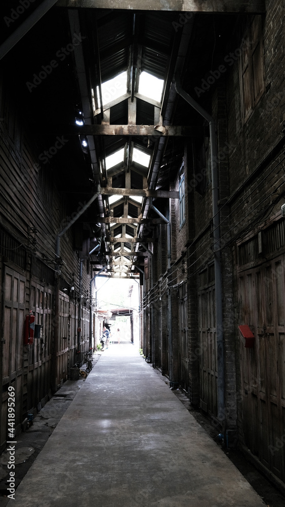 June 16 2021, Minburi, Thailand : Dark narrow alley an old town of Minburi old market, undeveloped area with old buildings.