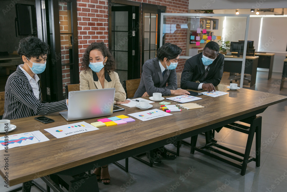 Selective focus of business team meeting in the office. They wearing as face mask to prevent themselves from Covid-19 pandamic Selective focus of business team meeting in the office. They wearing as face mask to prevent themselves from Covid-19 pandamic