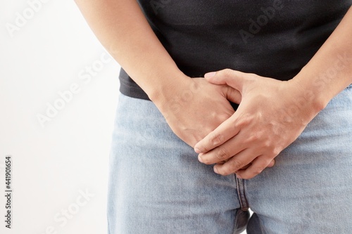 Close-up of a young man holding his penis cause pain prostate cancer ejaculation fertility bladder problems