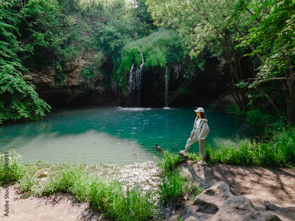woman hiker enjoying view of waterfall woman hiker enjoying view of waterfall