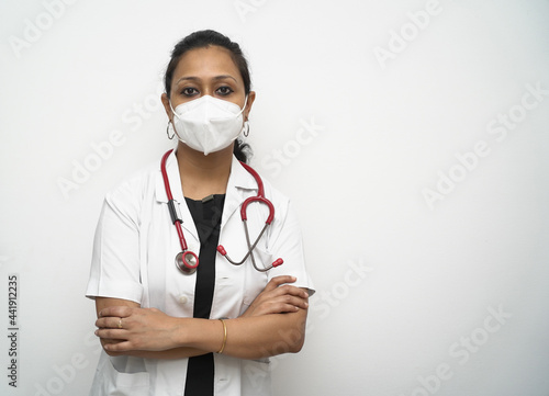 A south Indian female doctor in 30s with with mask white coat and red stethoscope