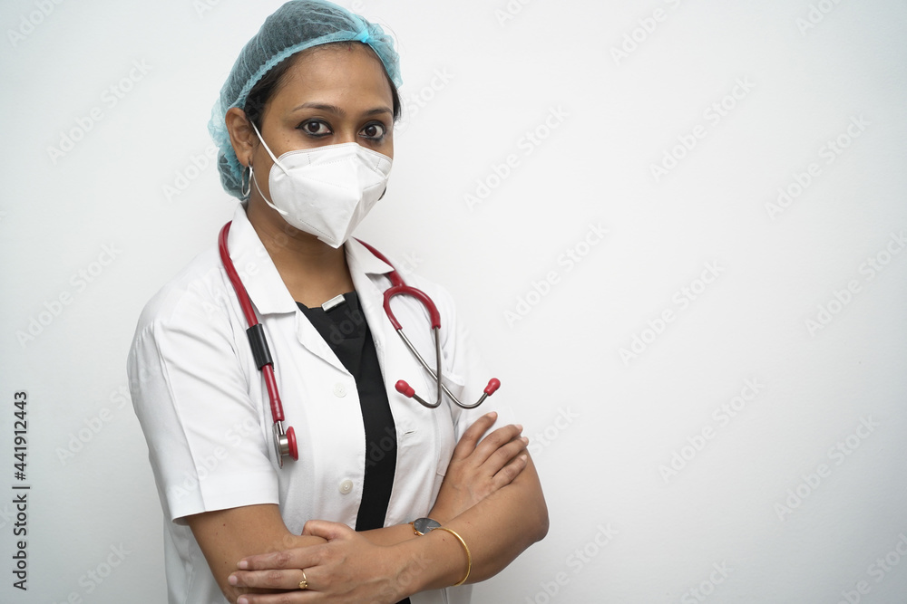 A south Indian female doctor in 30s with with cap mask white coat and red stethoscope A south Indian female doctor in 30s with with cap mask white coat and red stethoscope