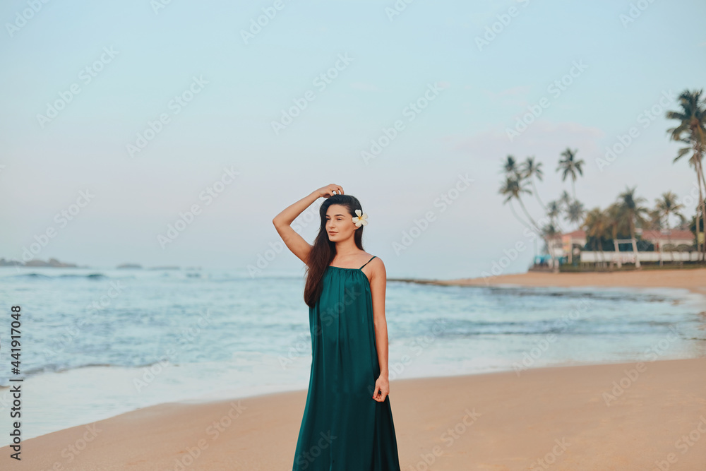 Portrait of beautiful young woman in dress on the beach. Pretty girl on tropical beach. Freedom concept, holiday, beach, sky background. Portrait of beautiful young woman in dress on the beach. Pretty girl on tropical beach. Freedom concept, holiday, beach, sky background.