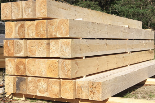 the beams are stacked. sawing logs into boards. construction of a house from a bar.
