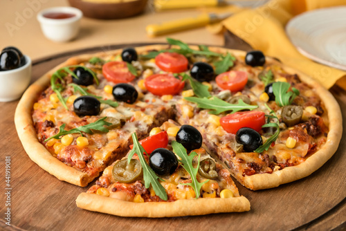 Board with tasty pizza on color background, closeup
