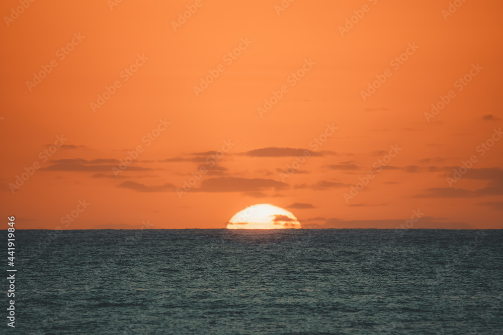 A sunrise over a beach.