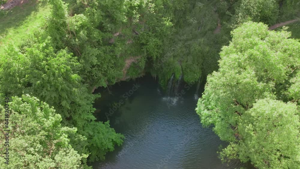 top view of small waterfall with blue lake top view of small waterfall with blue lake