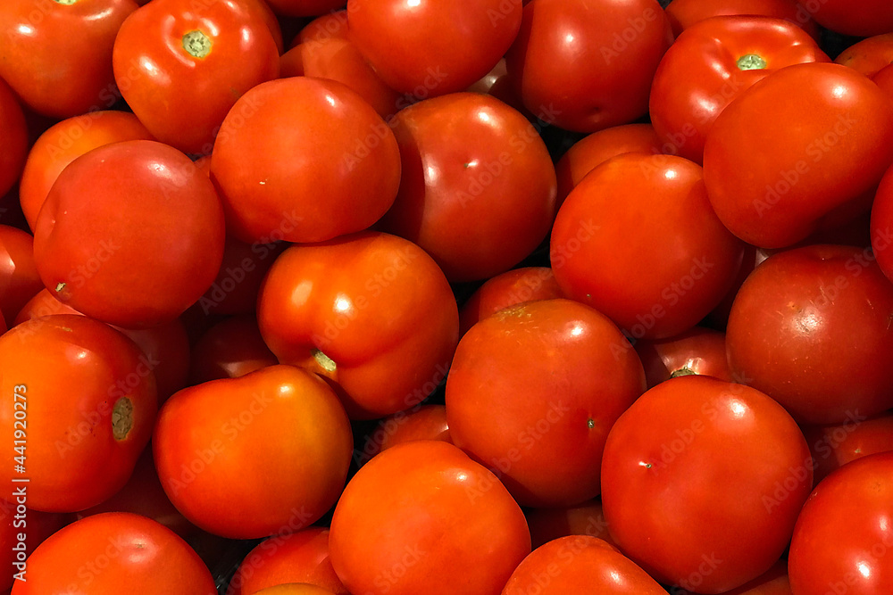 Fresh ripe tomatoes piled on the market. Food backgroumd. Harvest Fresh ripe tomatoes piled on the market. Food backgroumd. Harvest