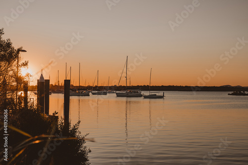 Boats and yachts sitting on the river at sunset near the Yamba Marina on the Clarence River. © Nick