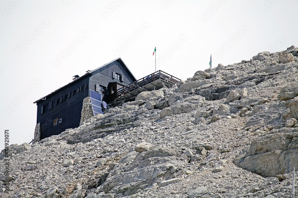 Fototapeta premium Mountain hut at the Pordoi in the Sella group in the Dolomiltes, a mountain range in northeastern Italy