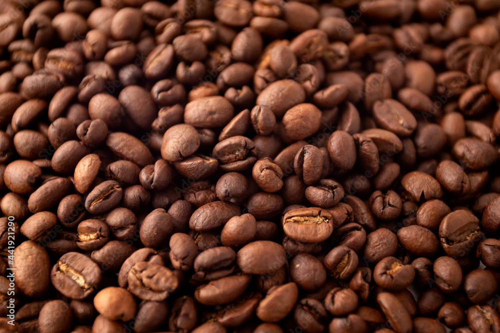 Coffee beans background. Roasted coffee fullframe. Texture of dark coffee beans.