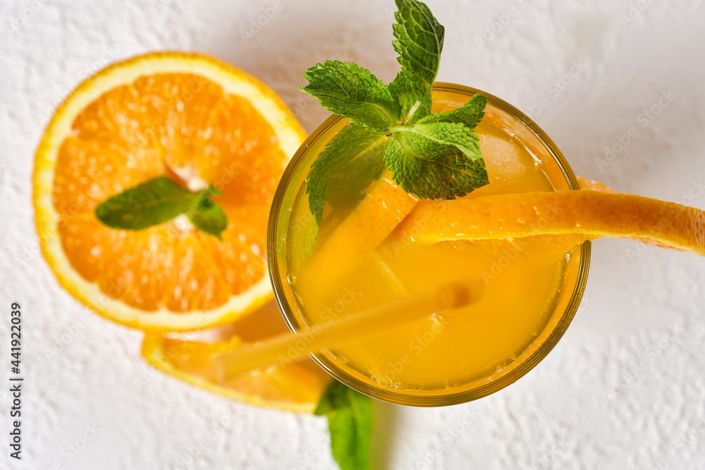 Orange drink with mint and ice in glass Orange drink with mint and ice in glass