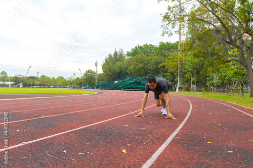 Canvas Print young Asian man athlete running and training on the running track