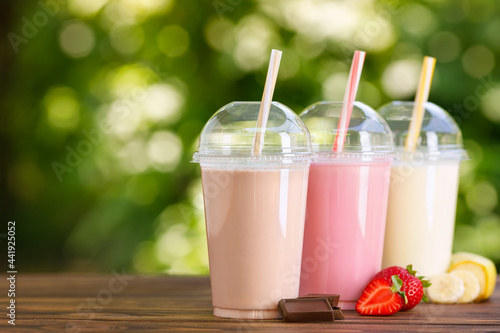 Obraz na płótnie set of different milkshakes in disposable plastic glasses
