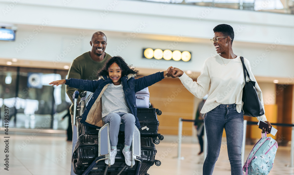 African family going on a holiday at airport StockFoto Adobe Stock
