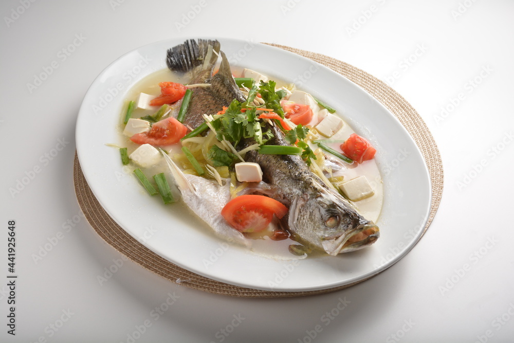 steamed fresh whole grouper fish with beancurd, tomato, sour vegetable and ginger in teo chew style asian halal menu steamed fresh whole grouper fish with beancurd, tomato, sour vegetable and ginger in teo chew style asian halal menu
